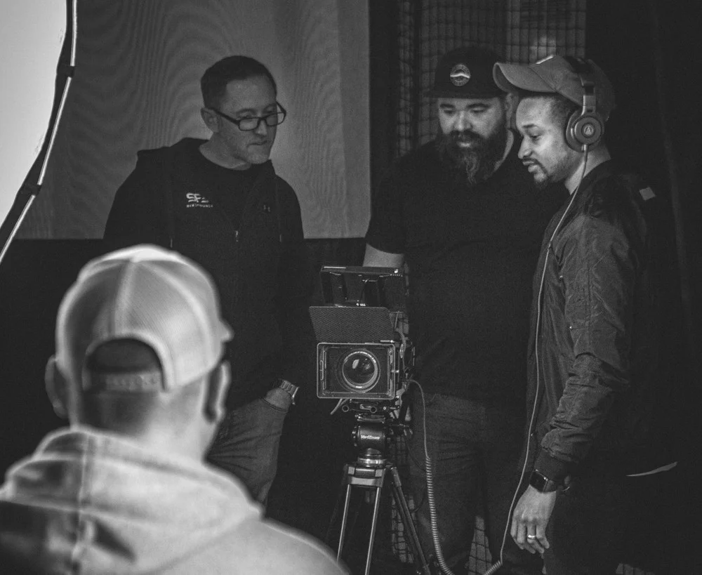 Washington DC creative services video production crew behind the scenes reviewing cinematic camera footage